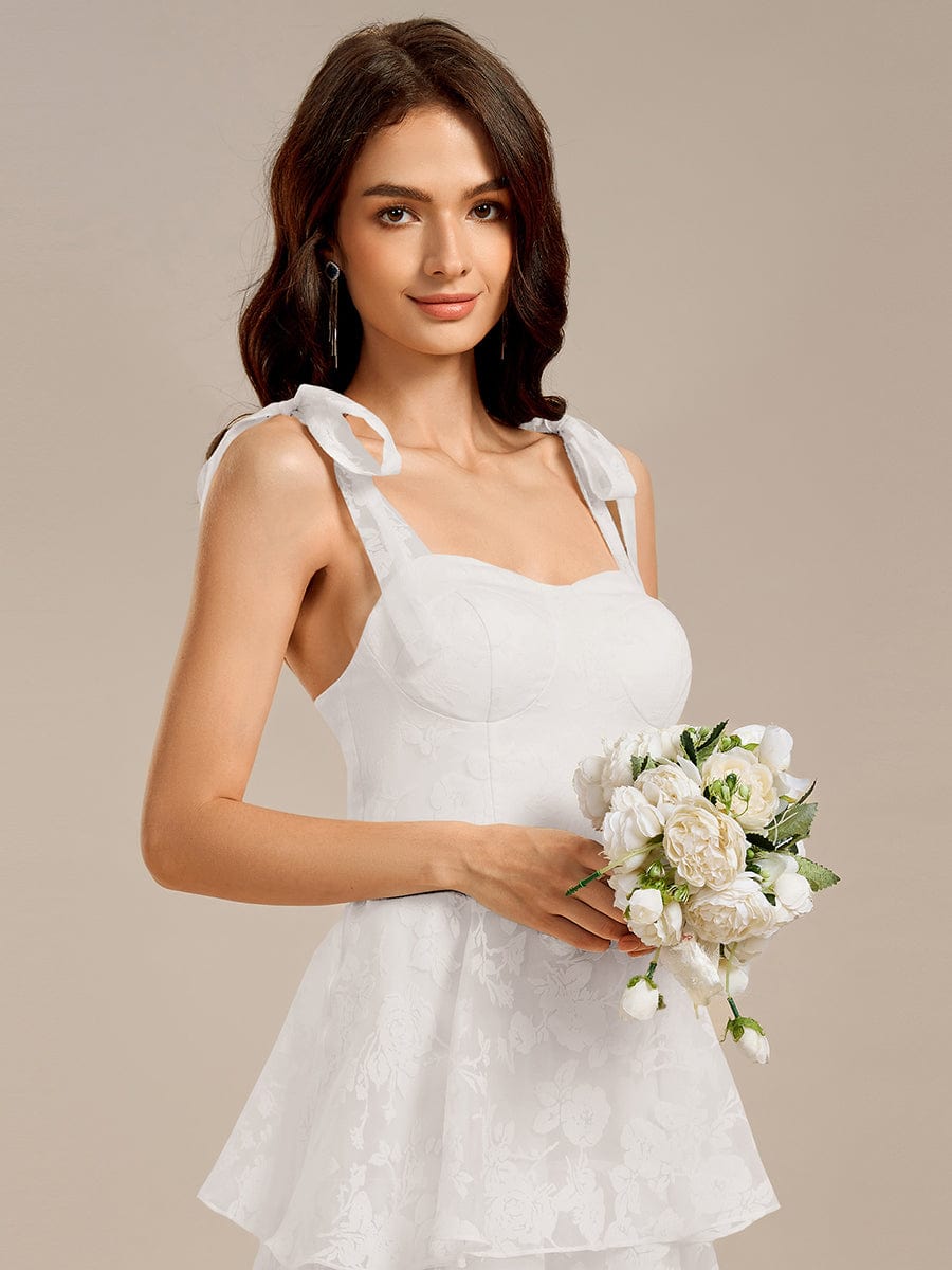 Robe de mariée mi-longue à volants et bustier à bretelles nouées et à fleurs #Couleur_Creme